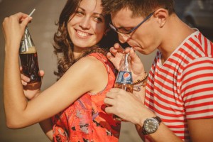 Close up of beautiful young smiling couple and drinking pepsi