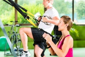 mand and woman exercising in the gym