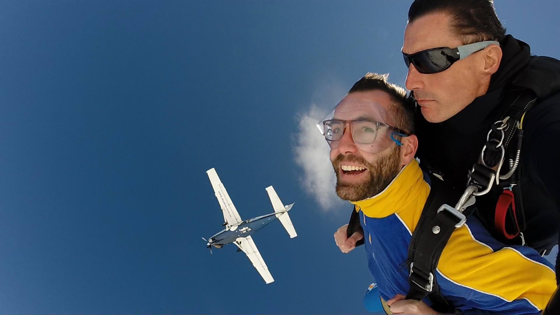 Skydiving with plane in background