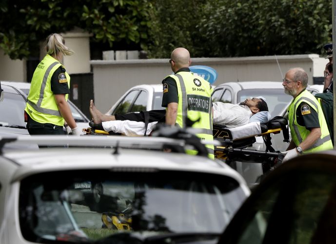 Ambulance staff take a man from outside a mosque in central Christchurch New Zealand