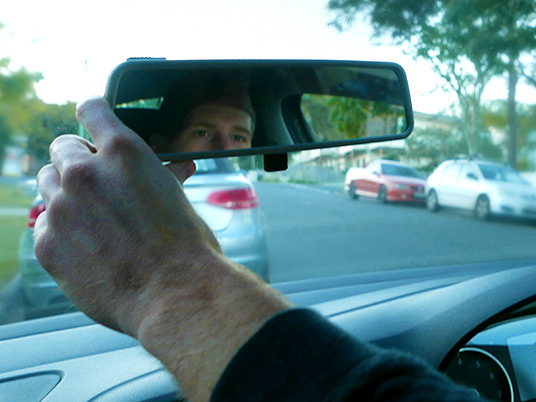 Driver looking in rear view mirror