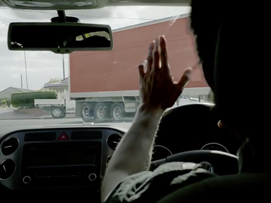 Driver giving courteous wave
