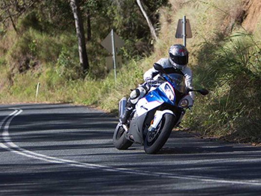 Motorcyclist rounding a bend on the road