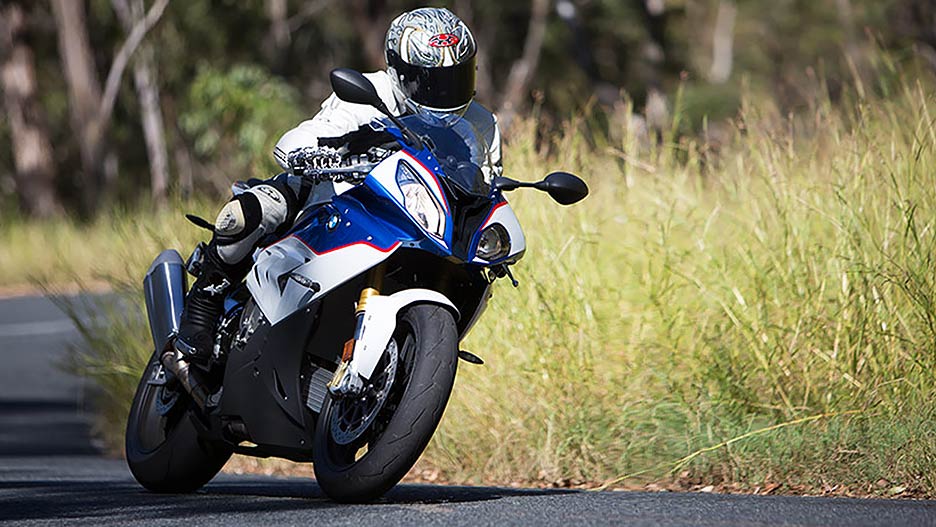 View of BMW motorcycle rider leaned over and taking a corner