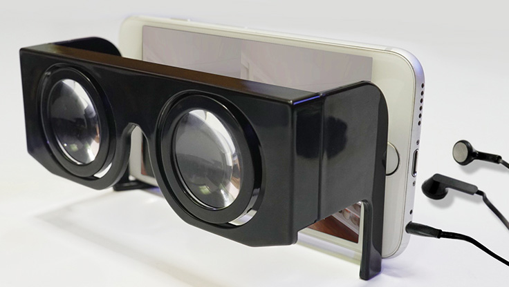 VR goggles a mobile phone and pair of headphones