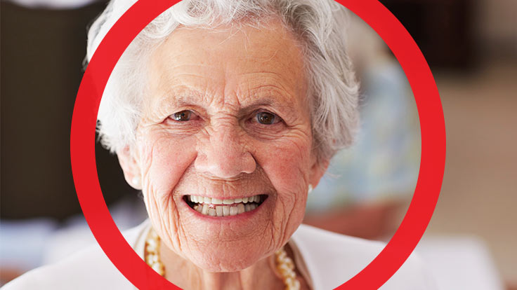 Portrait of older women with a big smile on her face with thick red circle framing her