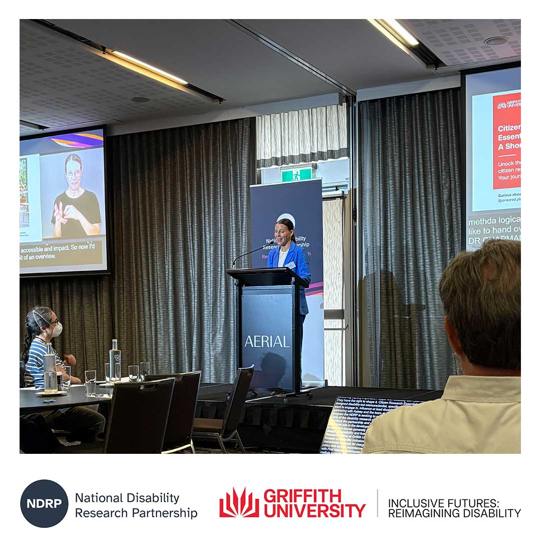 Project Lead and Inclusive Futures: Reimagining Disability Research Fellow at Griffith University, Dr Kelsey Chapman, stands at a podium addressing the audience during the launch event.