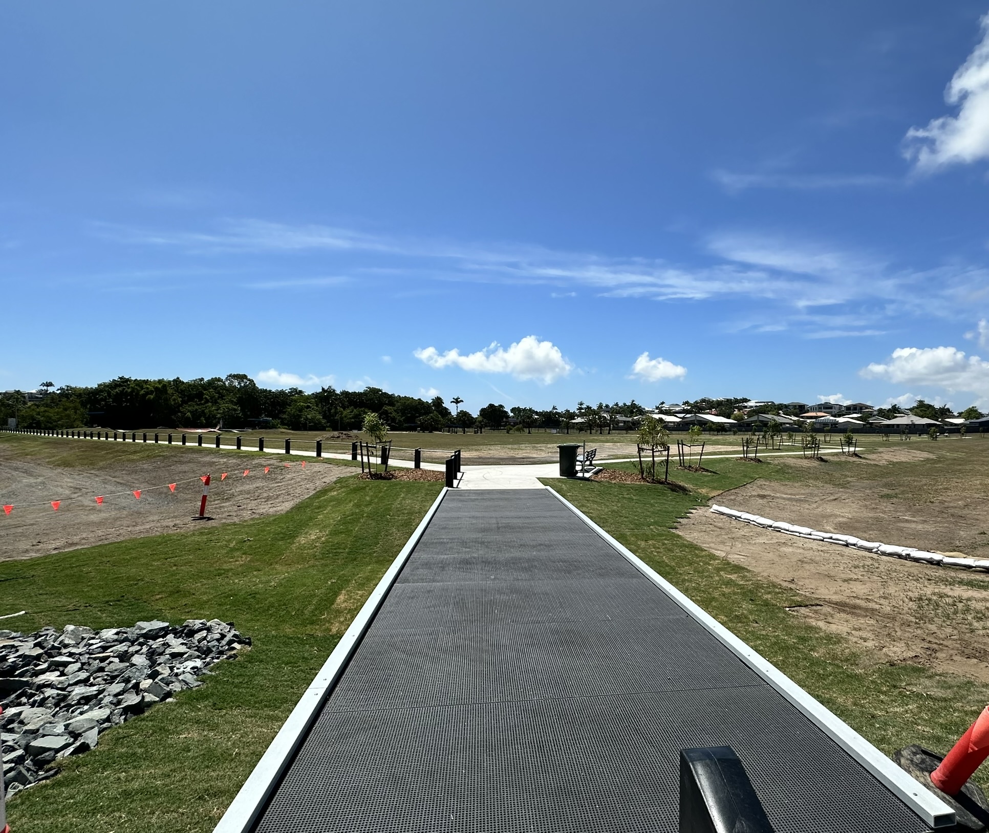 Image of Camilleri Street District Park boardwalk entrance with new concrete and pathway and seat.