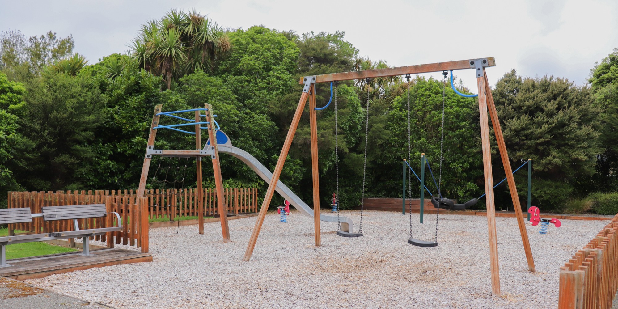 The old swings and slide at Ferndale Drive Park playground in Waikanae