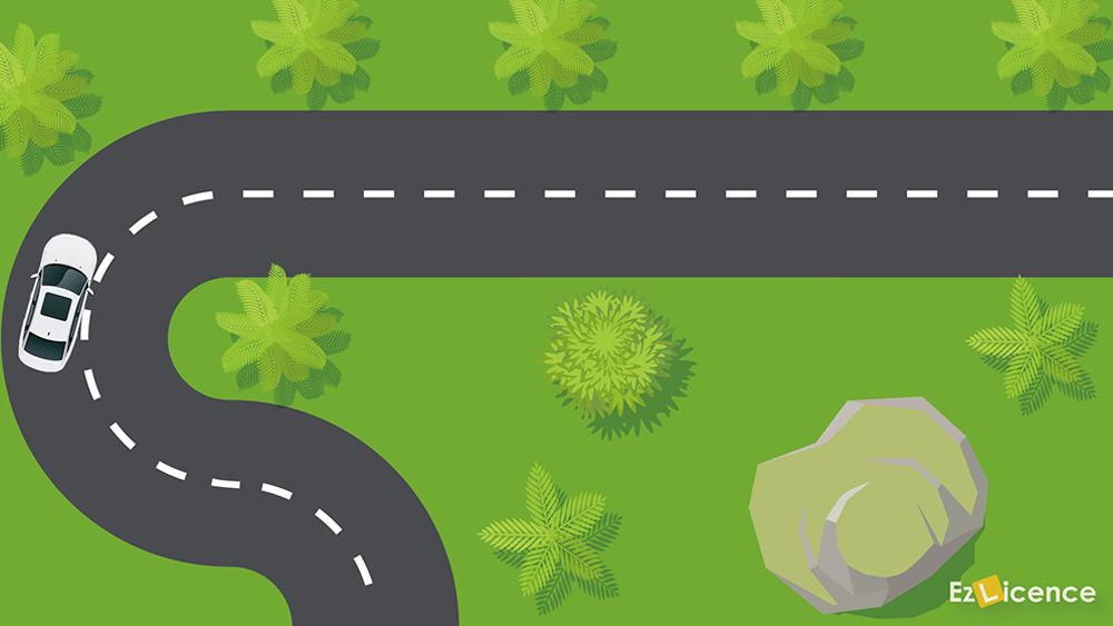 How should you drive out of a bend in the road?