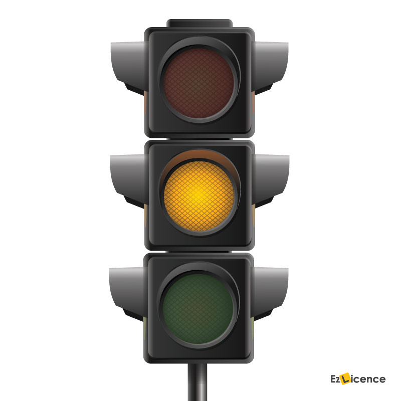 What should you do when approaching traffic lights which change from green to yellow?