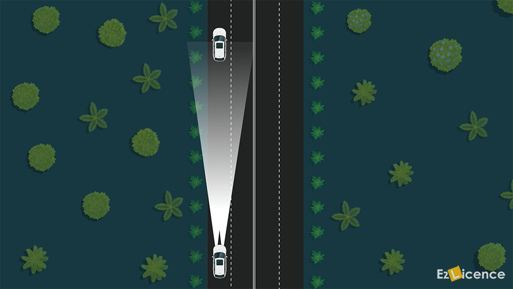 You are driving at night with your headlights on high beam. When should you change your headlights to low beam?