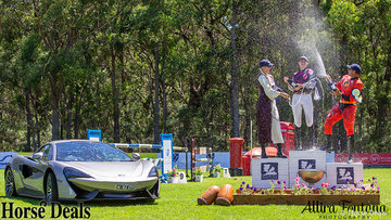 Winners of the Eventers vs Showjumpers next to the McLaren car, worth over $500.000!