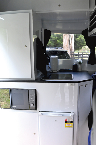 The kitchen with sink, microwave and 70L fridge is located in the nose of the float.