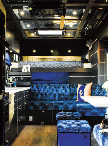The view towards the king bed in the luton peak. The truck can comfortably sleep seven, including one in the sleeper cab. The roof features a skylight and mirrored ceiling.