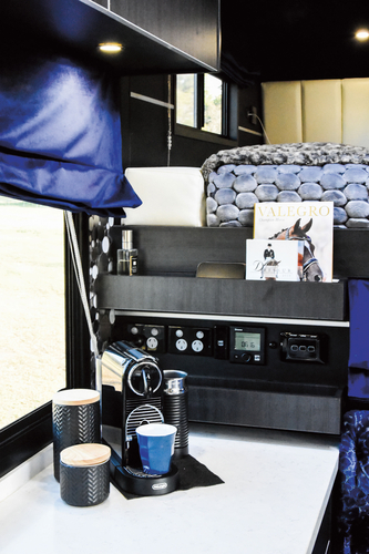 The coffee and media nook. This panel has USB and power points, and controls the sound system. Above is a book and magazine rack.
