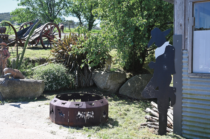 The fire pit, watched over by this cowboy who appears to be looking at his phone!?