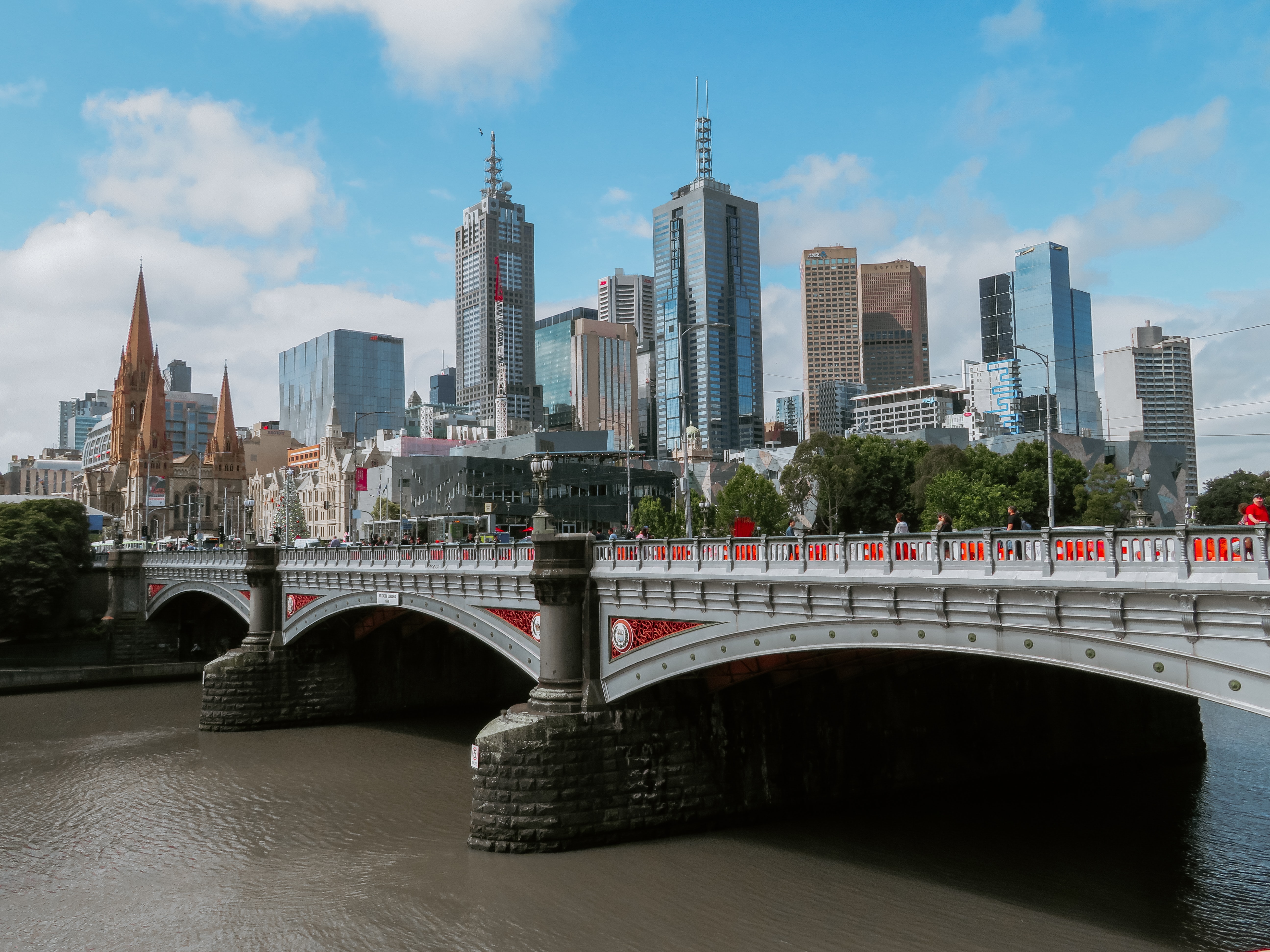 Bridge going over the Yarra River in the foreground and Melbourne city skyline in the background