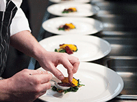 Chef assembling hors d'oeuvres in kitchen