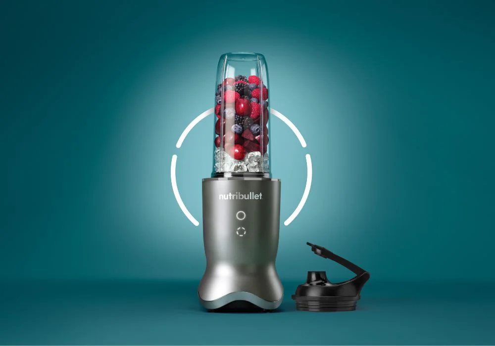 3 Nutribullet personal blenders with fresh fruits and vegetables in them.