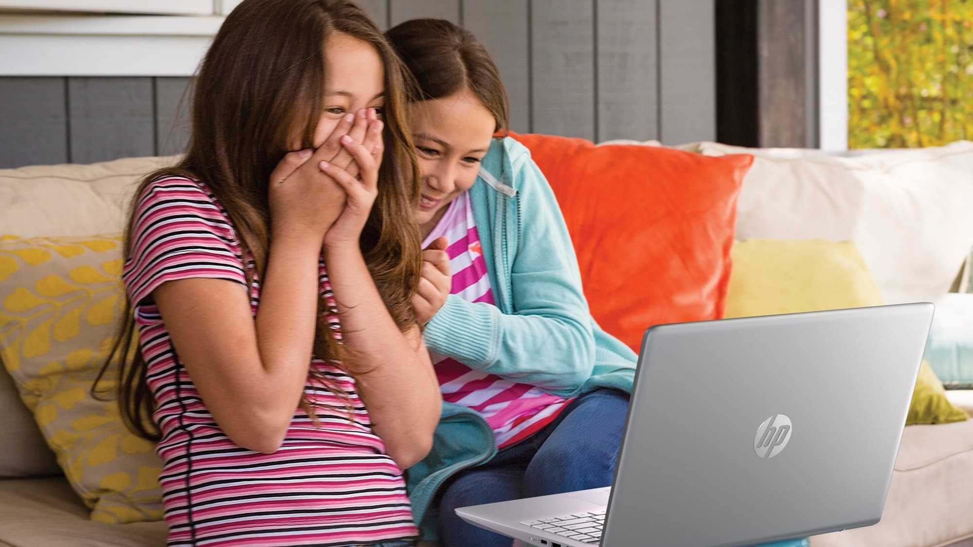 Children laughing at a laptop screen