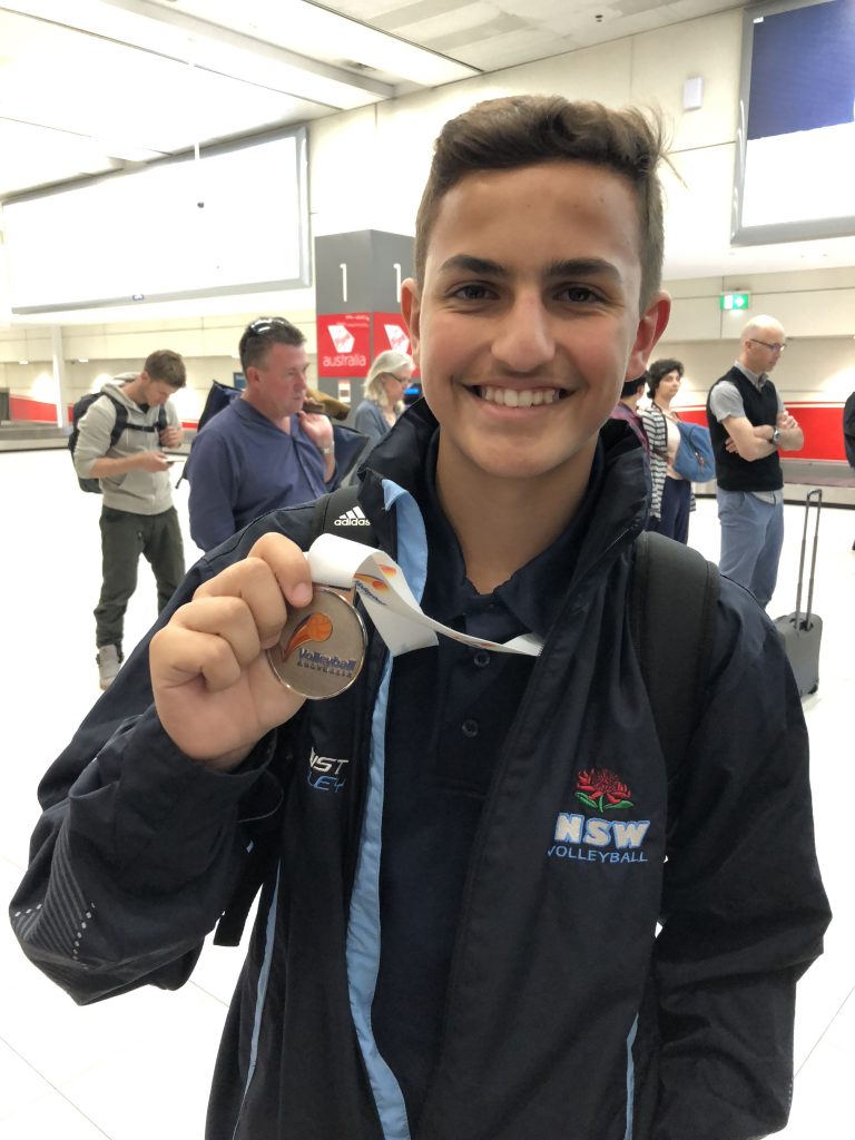 igs-student-at-state-volleyball-tournament-with-medal