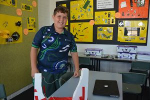 Buzzer challenge and posters with deconstructed items behind