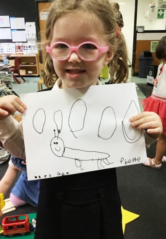 igs-early-learning-student-with-insect-drawing