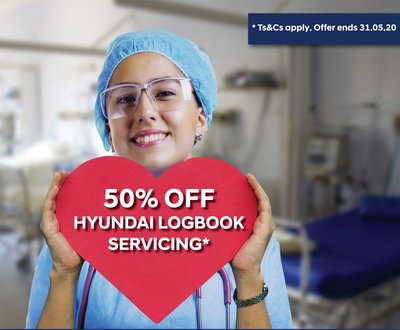 Health care worker in scrubs holding sign image