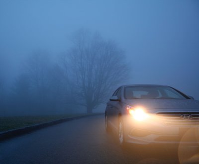 Car driving in wet and dark conditions image