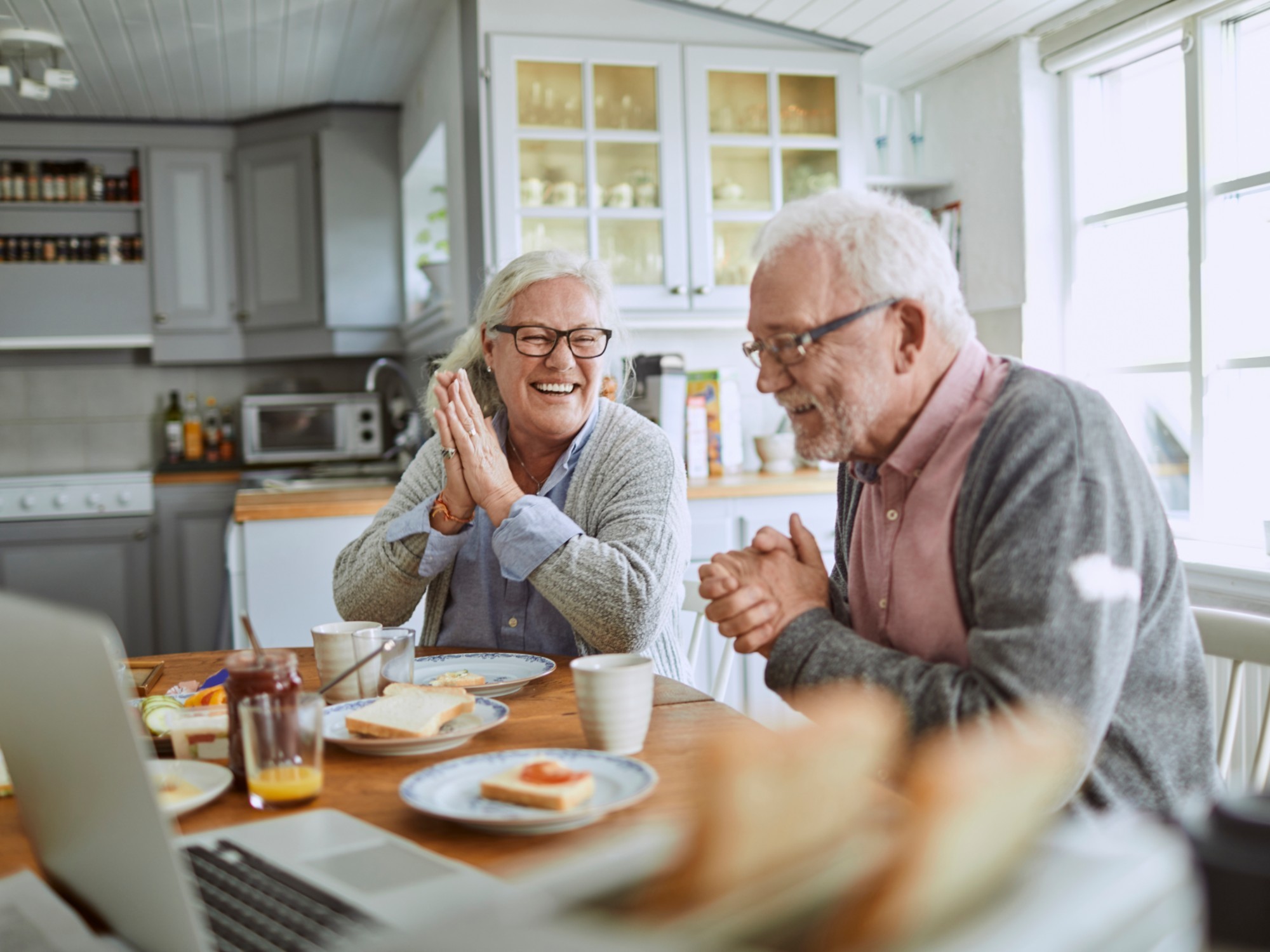 Elderly couple enjoying food at the table