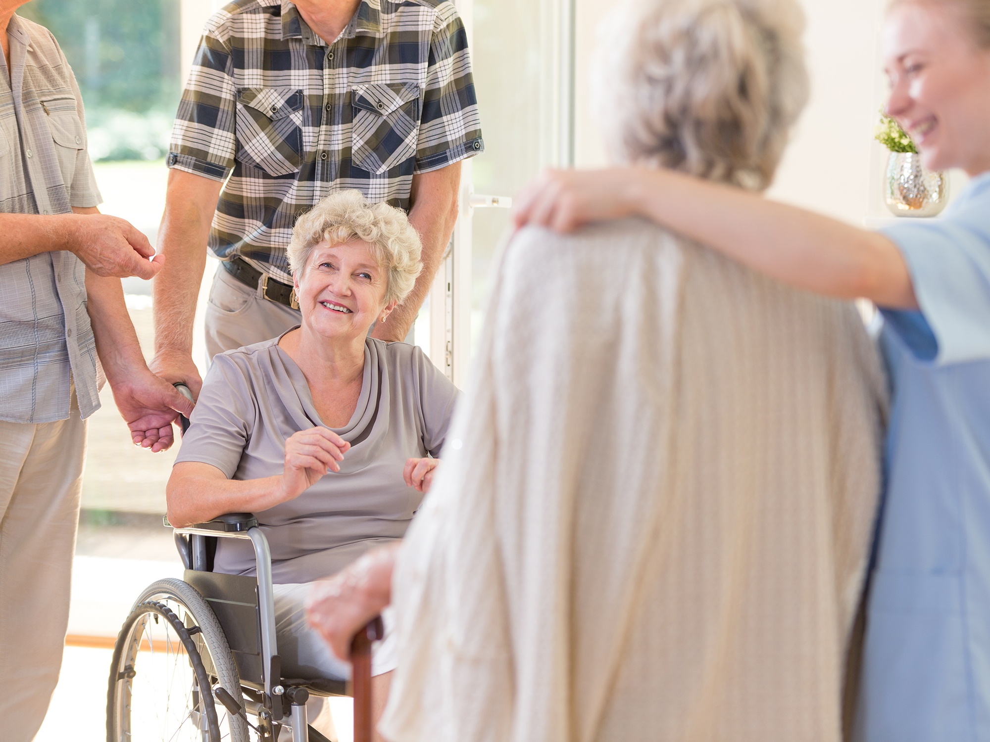 Woman catching up with other residents in aged care