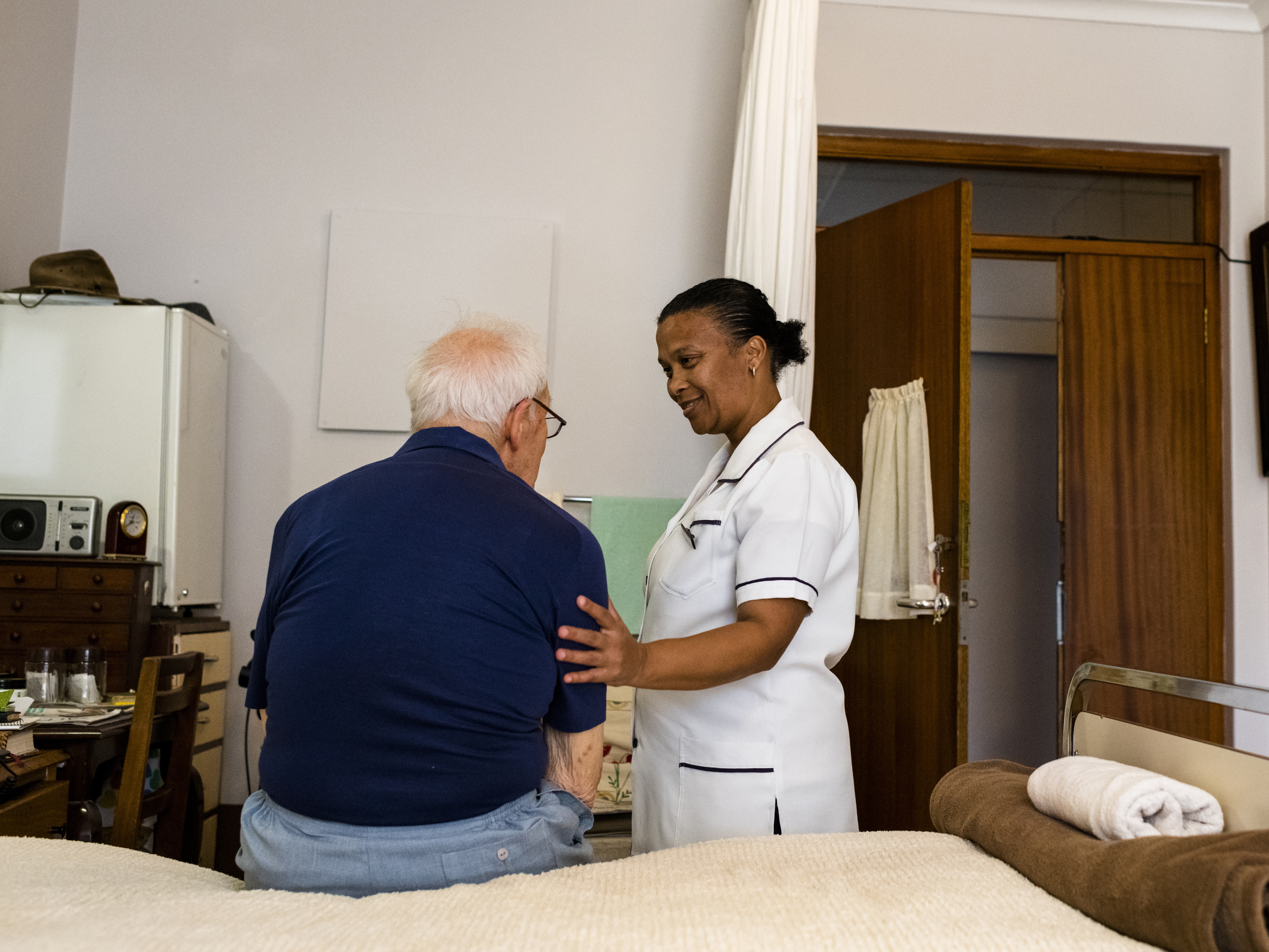 Nurse with an older resident at a nursing home.