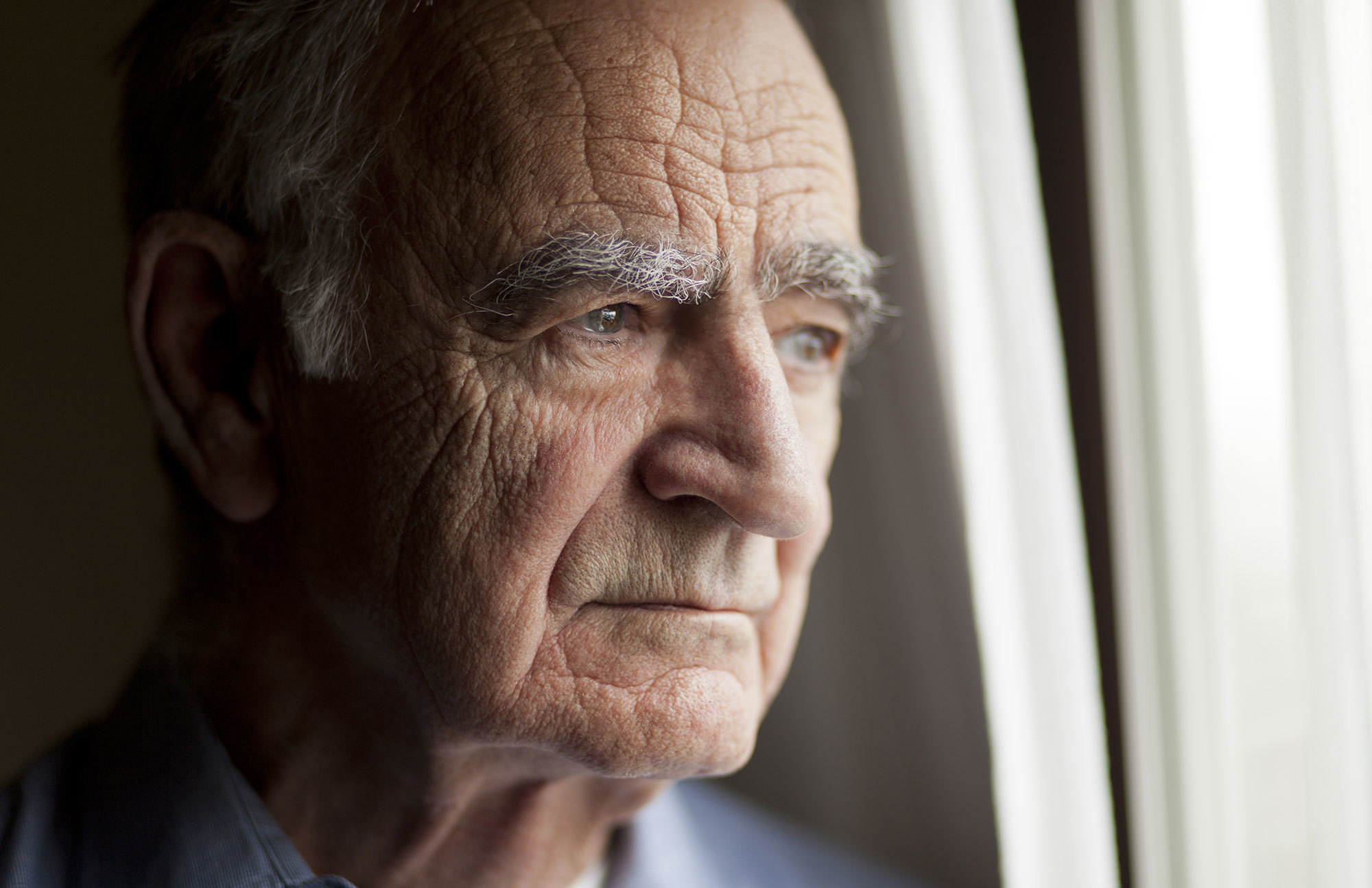 Older man looking out the window