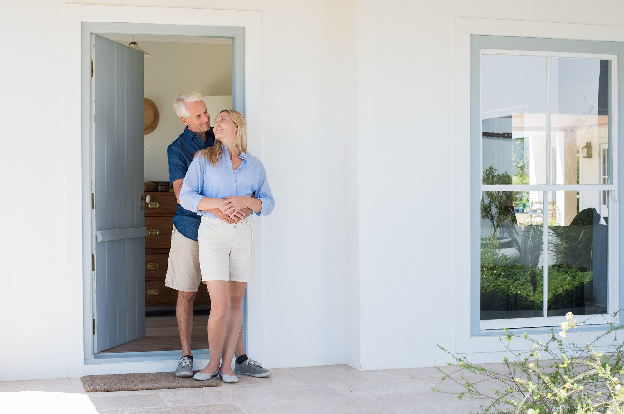 Older couple outside their retirement home.