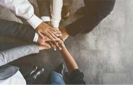 A team of business people putting their hands together