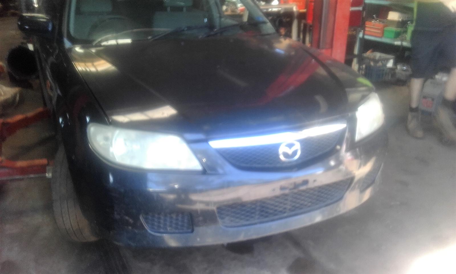 View Auto part Overflow Bottle Mazda 323 2001