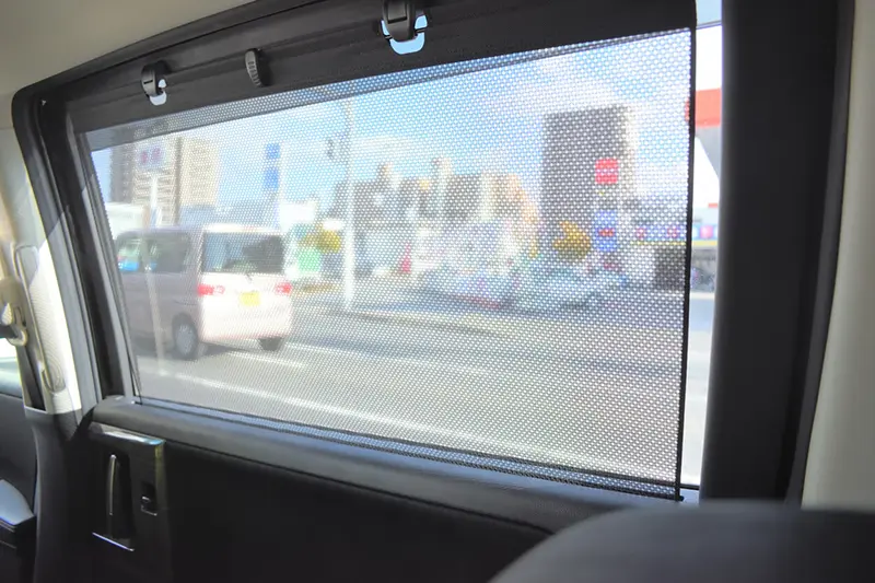 Interior of car window with a sun visor fitted