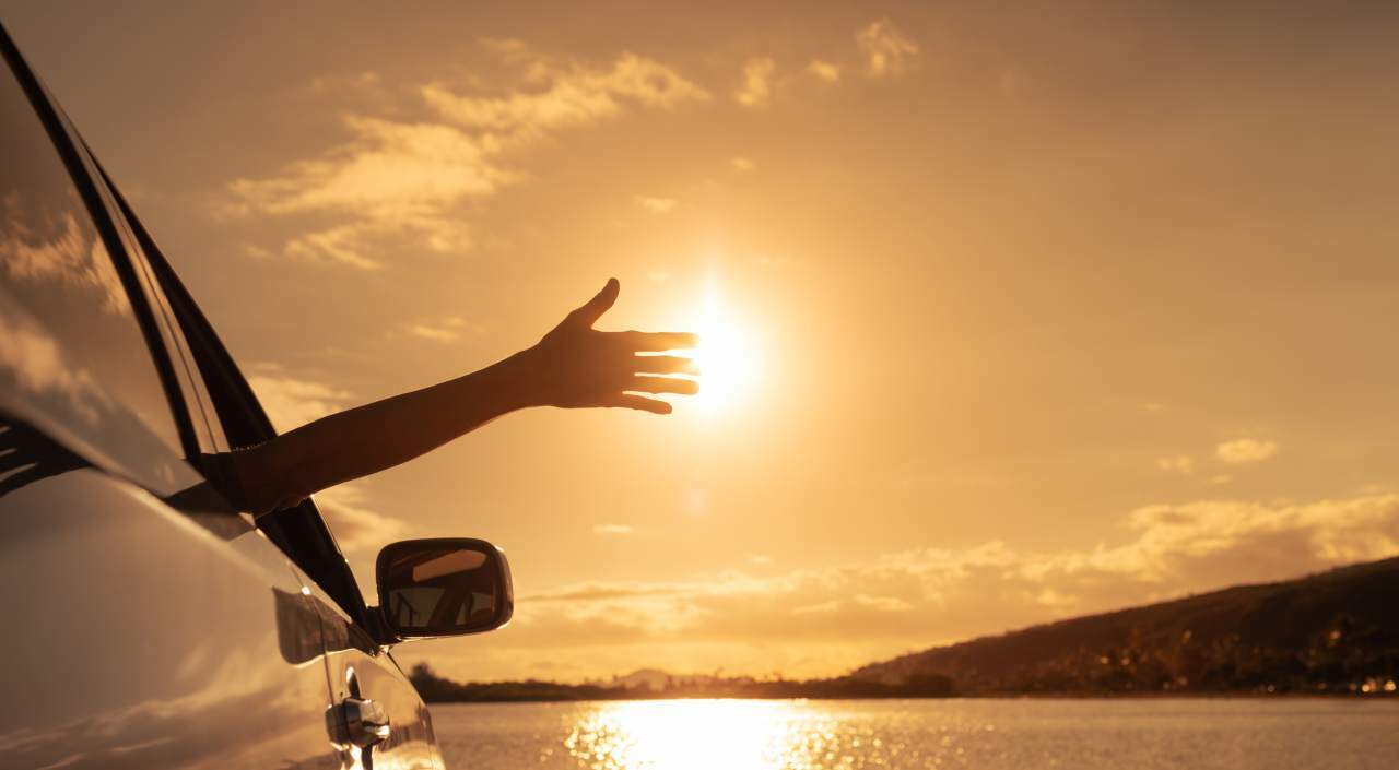 It is always a good time to take a look at how you may be using more fuel than you need to Idyllic scene of parked motorist at sunset, waving from car across a still lake