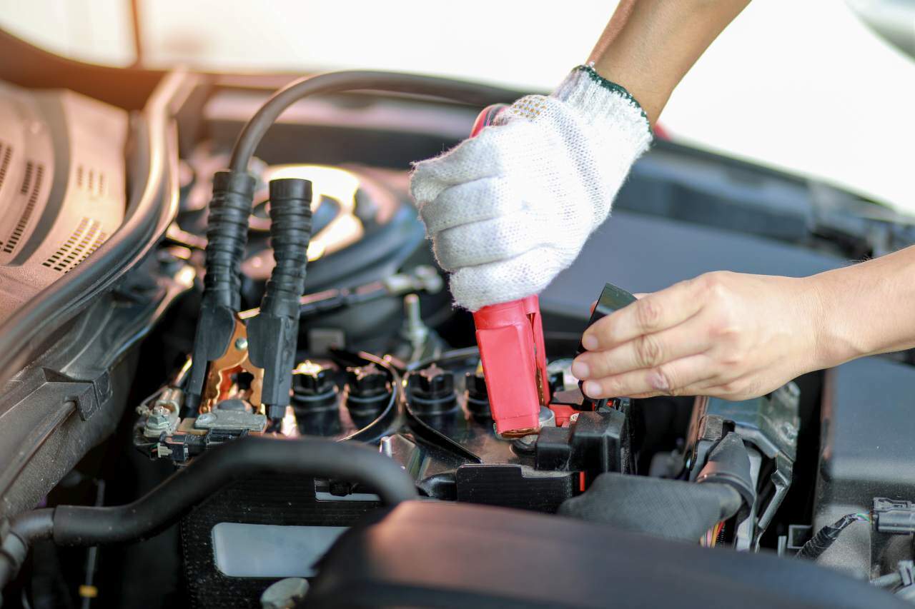 Close up charging your car battery with electricity through jumper cables.