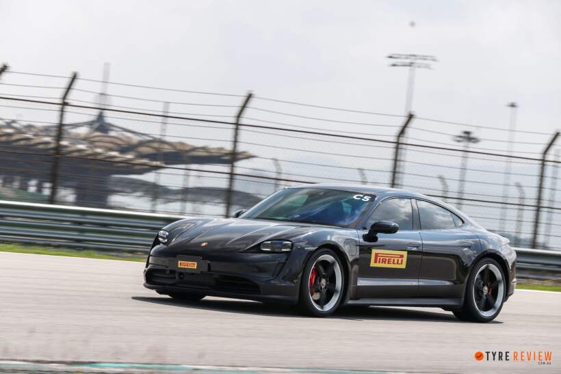 Front view of Porsche Taycan driving on track fitted with Pirelli P Zero 5 performance tyres