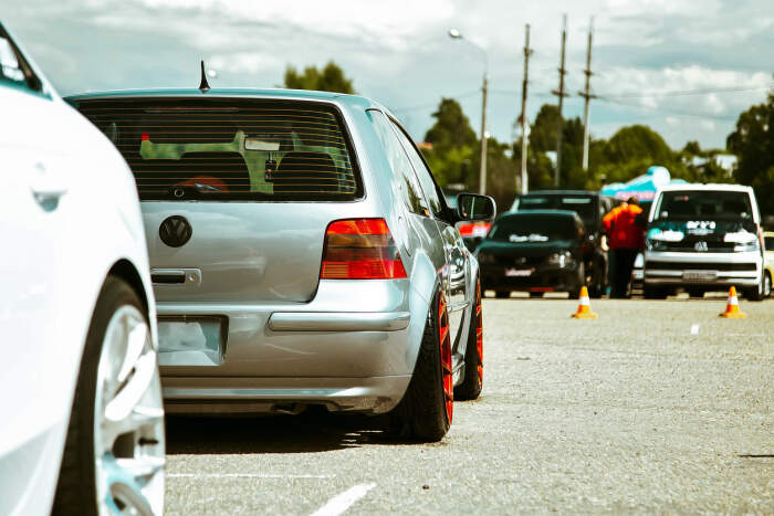 Volkswagon golf with low suspension and red aftermarket wheels