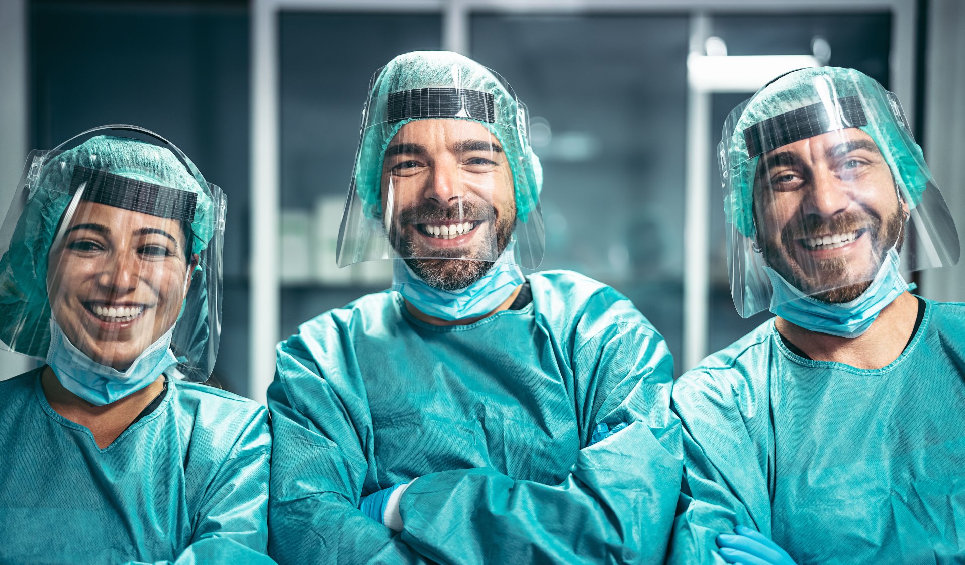 Three smiling clinicians in PPE