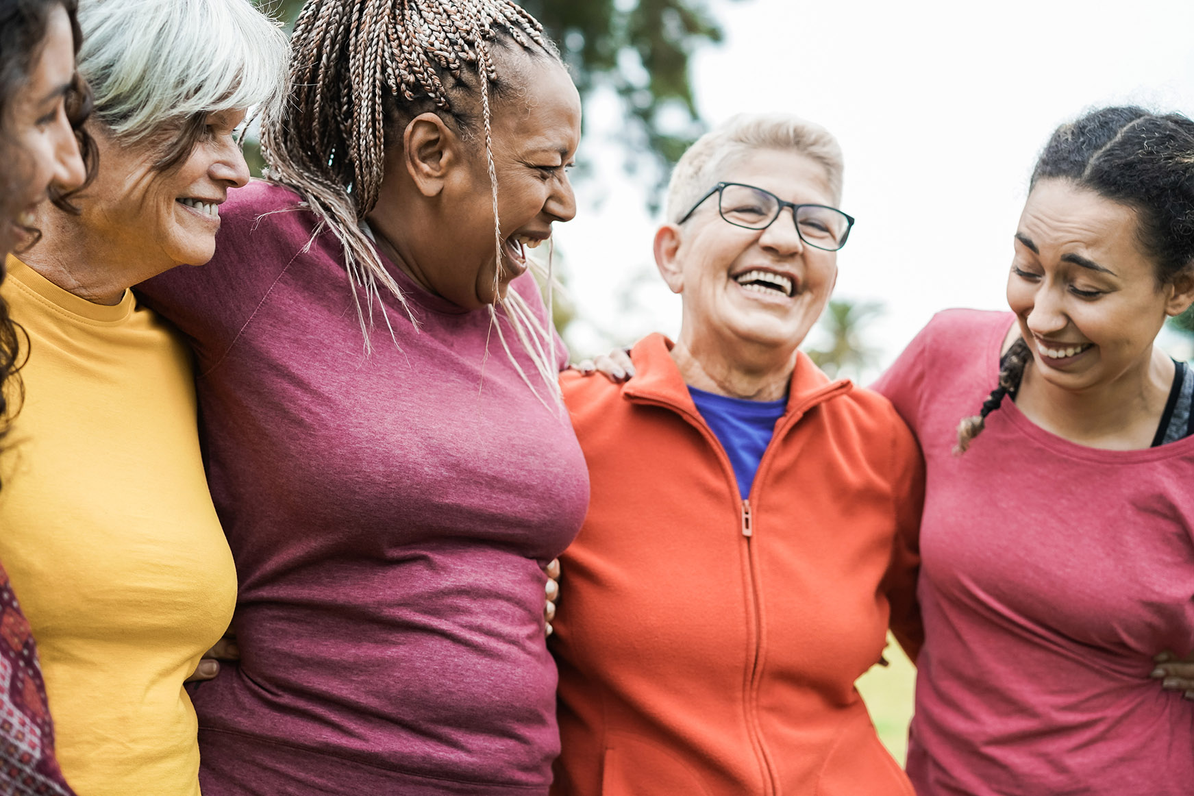 a group of women support each other in a park