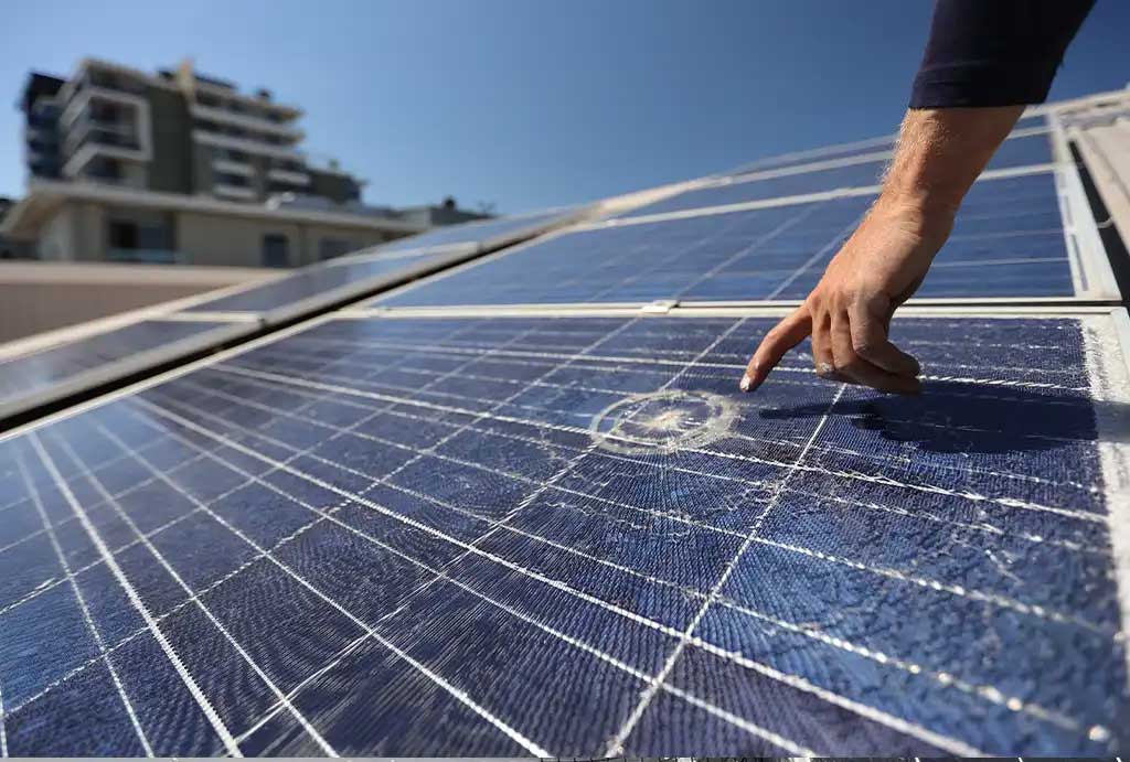 Technician pointing at micro cracking on a solar panel
