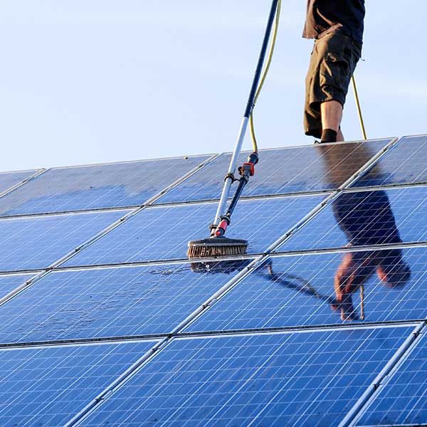 True North cleaning solar panel on a roof