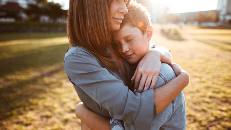 teenager embraced with mum