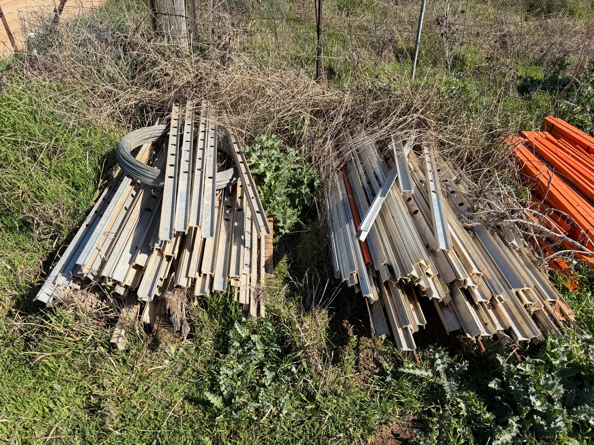 Pallet of Steel Fence Posts and Wire Coils