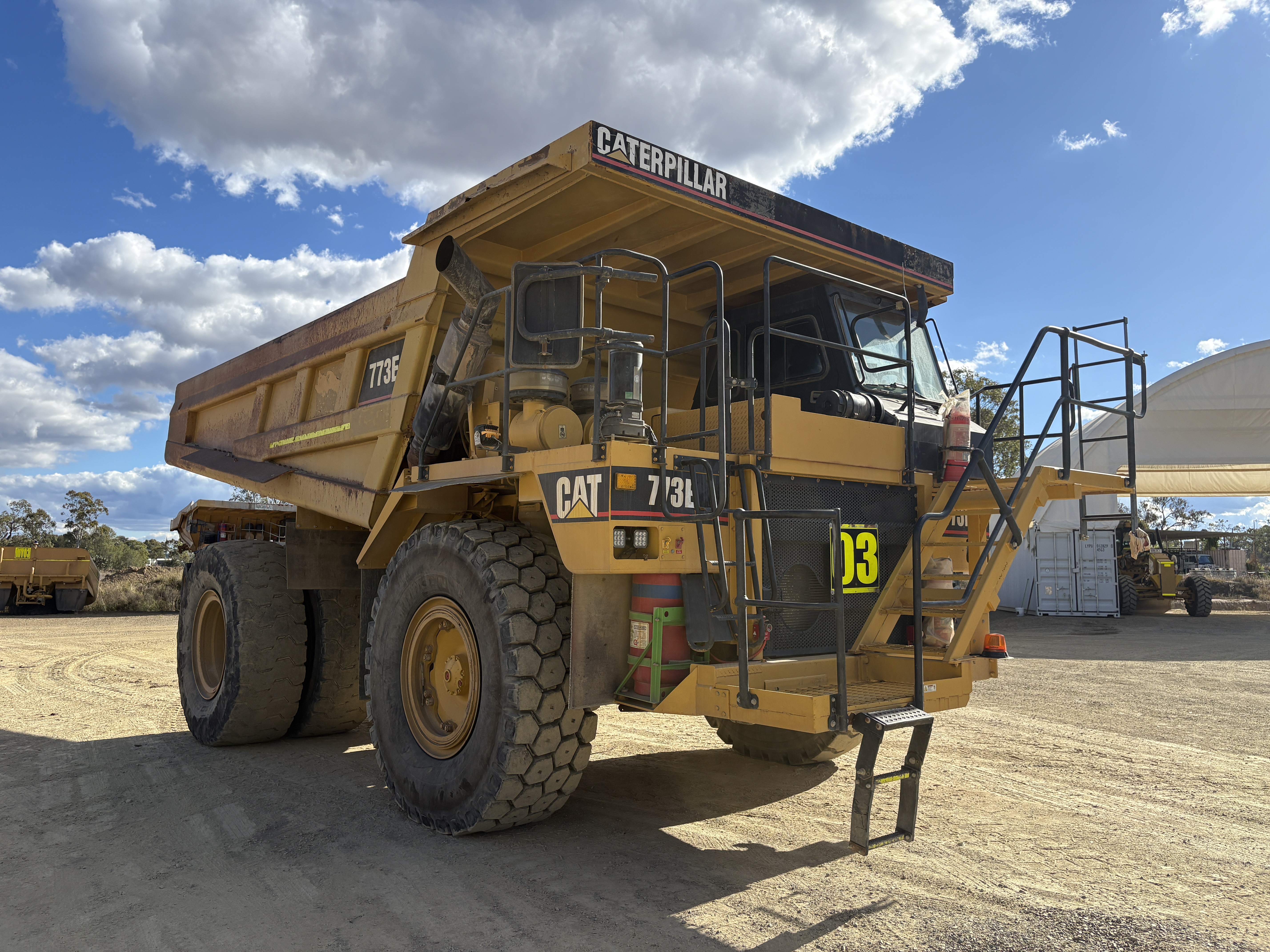 12 · 2003 Caterpillar 773E Dump Truck W/ Additional Water Body