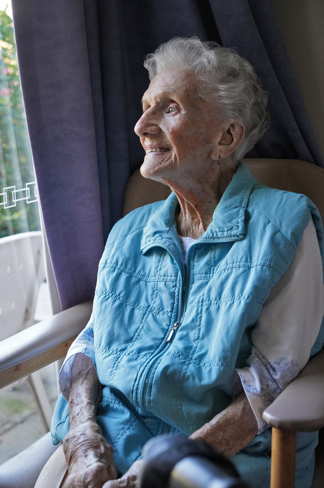 Bobby, aged 90, sits by a window reminiscing on her WWII service